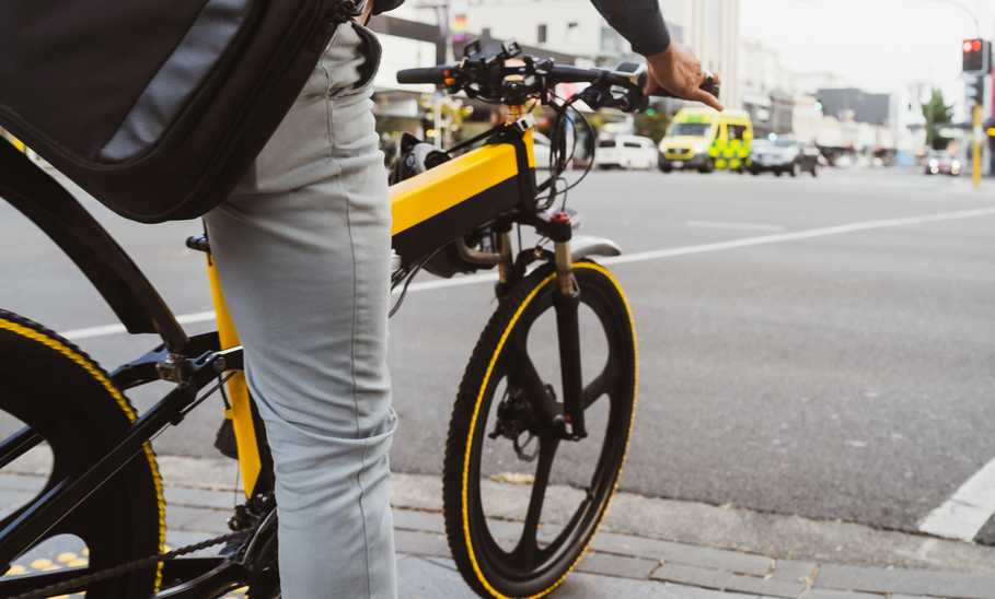 Person waiting on signal while riding on e-bike