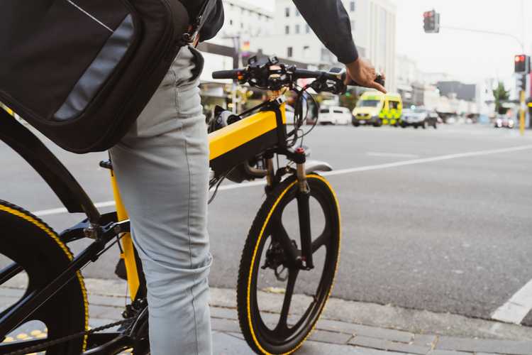 Person waiting on signal while riding on e-bike